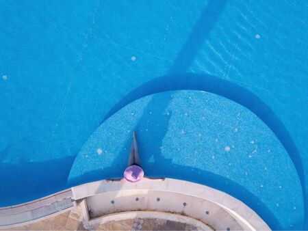 Young woman sunbathing in a swimming poolの写真素材