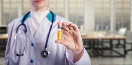 Doctor holding a coronavirus vaccine ampoule, Covid-19 vaccine.の写真素材