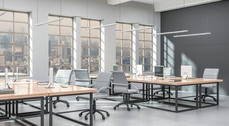Side view of a modern office with a grey wall. Rows of tables, equipped workstations. 3d rendering.の写真素材