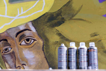 An original graffiti painting of a woman in helmet on a concrete wallの写真素材