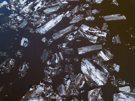 The ice floes floating on the river. The ice drift in spring timeの写真素材