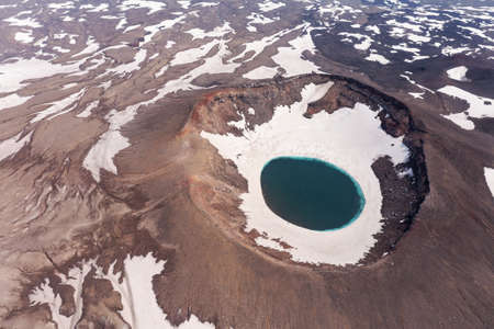 The blue lake in the crater of Gorely volcano. Kamchatka Peninsula, Russia