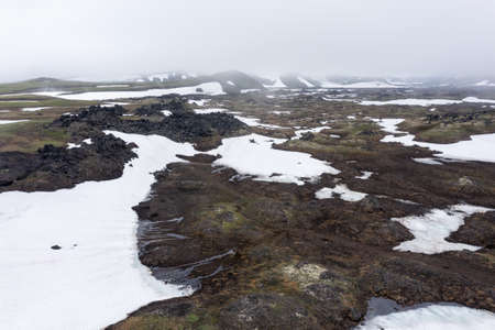 The magma stone field of Gorely volcano covered with fog. Kamchatka, Russiaの写真素材