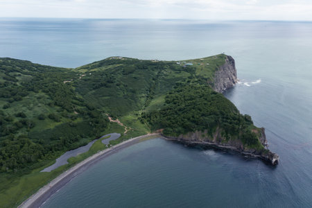 Aerial drone photo of Mayachny Cape on Kamchatka Peninsula on picturesque Avacha bay coast covered by green grass in the Pacific Oceanの写真素材