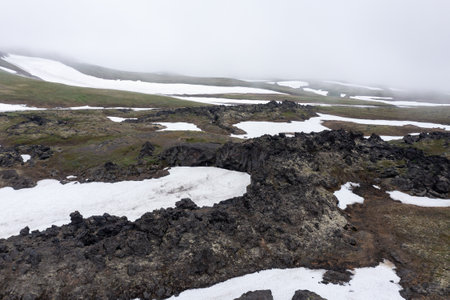 The magma stone field of Gorely volcano covered with fog. Kamchatka, Russiaの写真素材