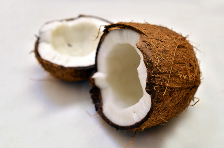 the broken fresh coconut on a white background