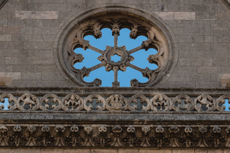 Stoned rose window and balustrade in main facade of gothic leon Cathedral in spainの写真素材