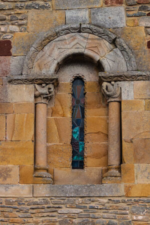 Delicate and beautiful romanesque window of the church of San Andres de Valdebarzana in Asturias Spainの写真素材