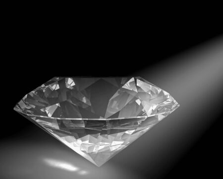 A diamond sparkles in a white spot light.の写真素材