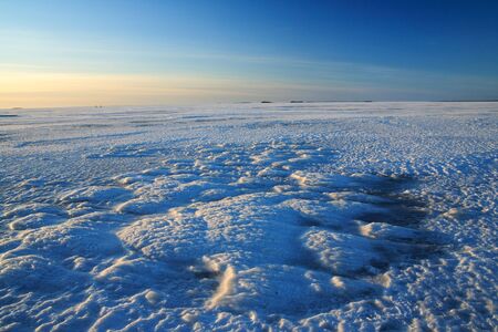 View from frozen sea in Finland during sunset