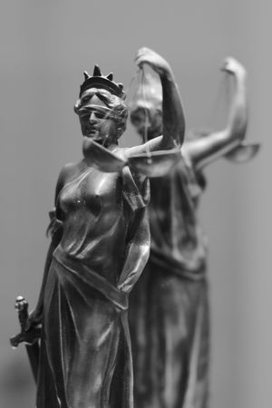 Old bronze statue of Justice in front of mirrorの写真素材