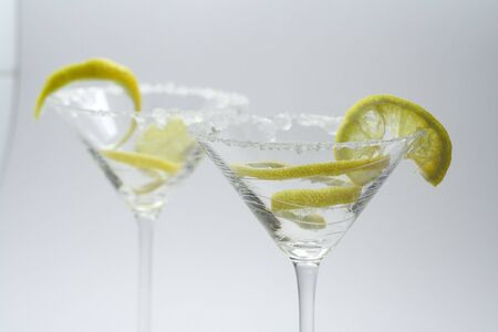 Martini with sugar crust, lemon and peels on whiteの写真素材
