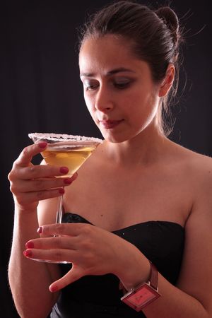 Beautiful young woman holding a martini glassの写真素材
