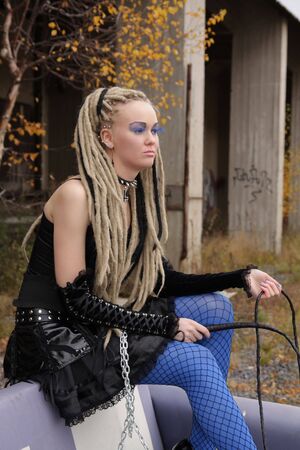 Young woman wearing punk clothing and makeup in deserted locationの写真素材