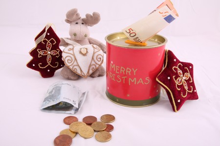 Christmas savings, euro bills and coins with velvet decorationsの写真素材
