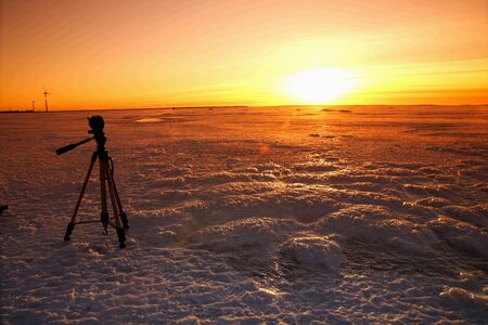 Sunset over frozen lake in winter, Finlandの写真素材