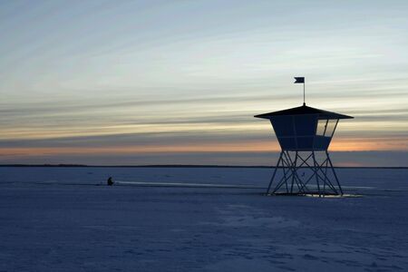 Sunset over frozen lake in winter, Finlandの写真素材