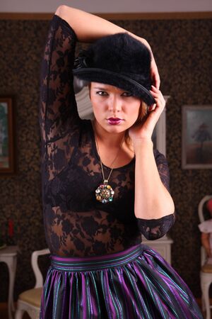 Beautiful young woman in an antique decorated house interior