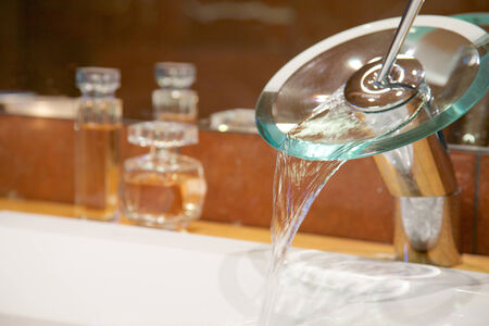 Modern faucet with running waterの写真素材