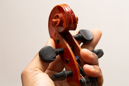 Close up view hand on Musical instrument acoustic guitar headstock adjust tuning pegsの写真素材
