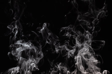 Graphic background with curls of white smoke on a completely black wall. Steam effect.の写真素材
