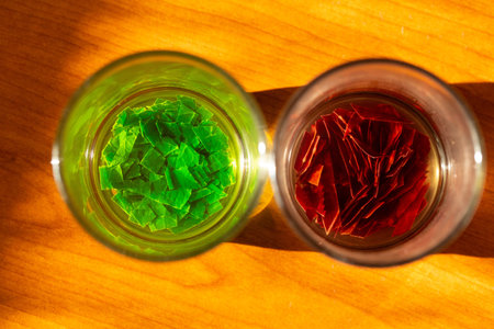 Essences of spring and autumn in small glasses on a wooden table, concept of seasons