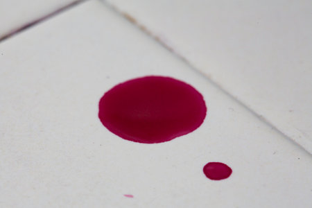 Close-up of a blood drop on a white sheet of paperの写真素材
