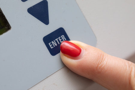 Finger pressing enter on a keypad