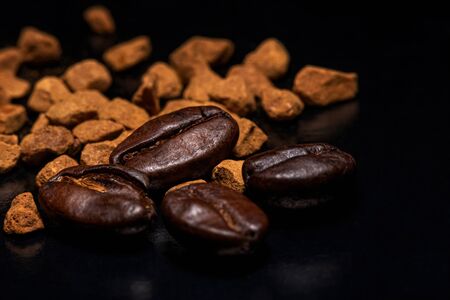 Coffee beans and instant coffee granules on a dark background, macro, close-upの写真素材