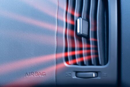 Car air conditioner with passenger airbag and illustration of hot air flow from it. Front view close upの写真素材