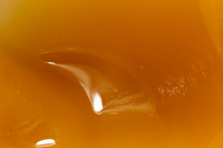 Honey orange textured liquid background, extreme close-up macro viewの写真素材