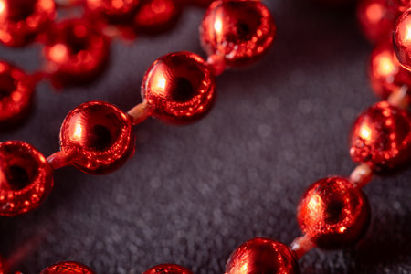 Red and bright Christmas pearls, Christmas tree decorations, garlands, decorations. Close-up macro photographyの写真素材