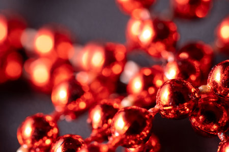 Red and bright Christmas pearls, Christmas tree decorations, garlands, decorations. Close-up macro photographyの写真素材