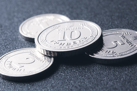 Modern Ukrainian coins on dark textured background, main coin denominations. Close-up macro photographyの写真素材
