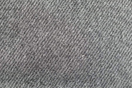 Black and grey denim background. High detailed backdrop texture of black and grey denim fabric....