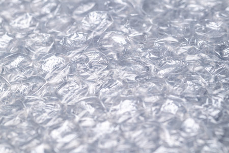 Bubble wrap macro photo with selective focus. It is a pliable transparent plastic material with...
