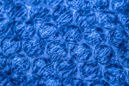 Bubble wrap macro photo with selective focus. It is a pliable transparent plastic material with...