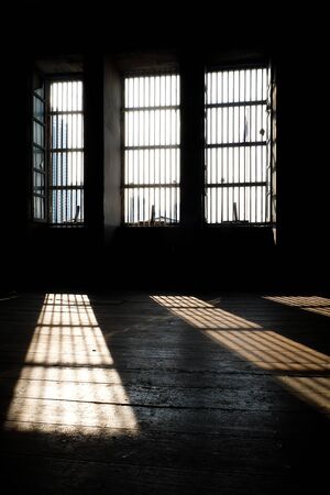Barred door and windows in abandoned house interiorの写真素材