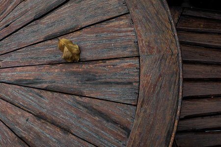 wheel obsolete cracked textured wooden grunge backgroundの写真素材