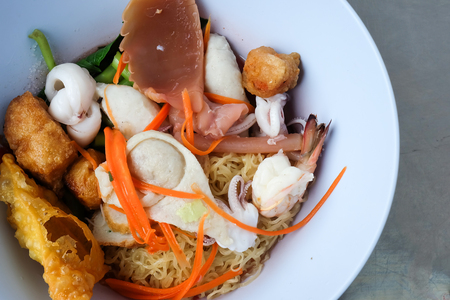 Pink seafood flat noodles morning glory squid and vegetable asia thai foodの写真素材