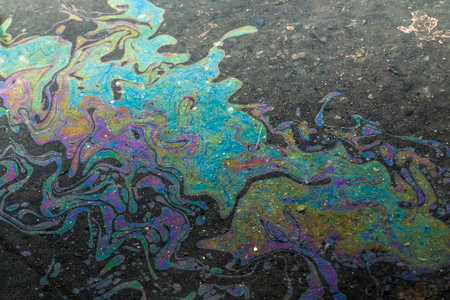 Bright colored chemical waste on the road when it rains