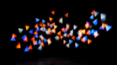 Electric-colored squares, triangles, and arrows in motion against a pure black backdropの素材