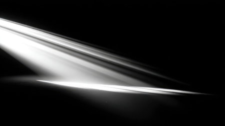 Abstract shot of light beams from a film projector slicing through darknessの素材