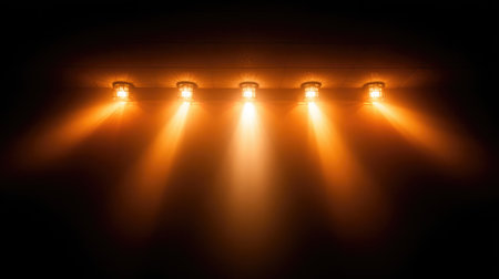 Isolated image of a cinema light fixture casting dramatic glow over theater wallの素材