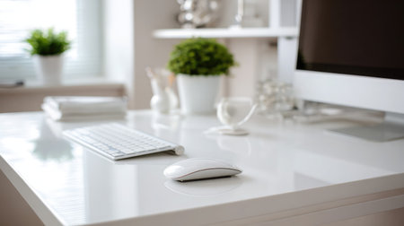 Flat mouse with gesture support placed next to high-end MacBook on white deskの素材