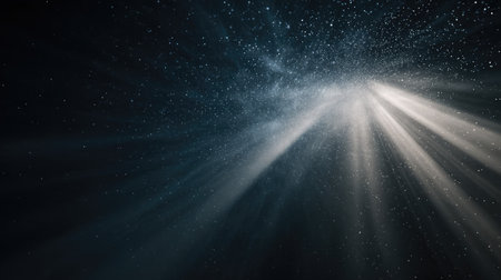 Abstract view of spotlight rays dispersing in dark space with subtle dust particlesの素材