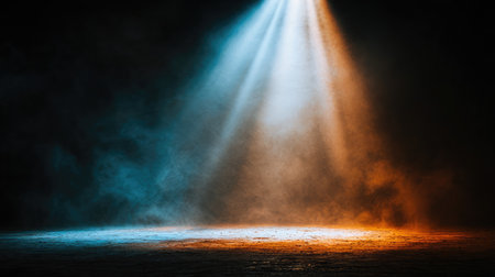 Beam of white spotlight breaking through smoke in a dark roomの素材