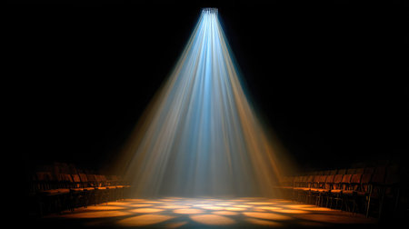 Narrow spotlight beam highlighting center stage, rest of the room in shadowの素材