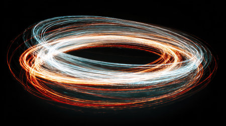 Circular neon shapes in motion blur forming artistic light trails in the darkの素材