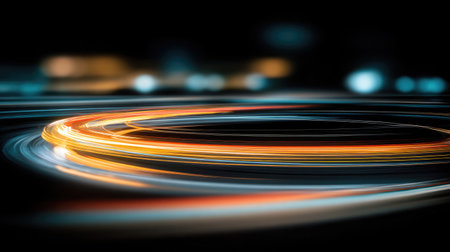 Circular neon shapes in motion blur forming artistic light trails in the darkの素材